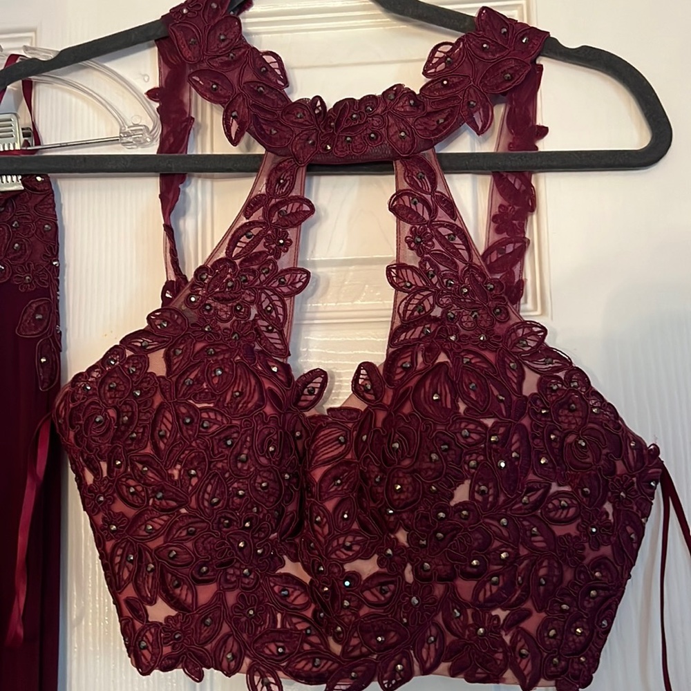 This prom dress is Burgundy, a size 2 with corset straps in the back. Worn once